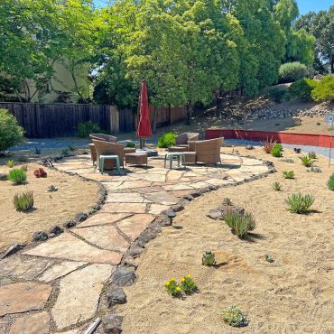 Flagstone terrace surrounded by succulents with decomposed granite