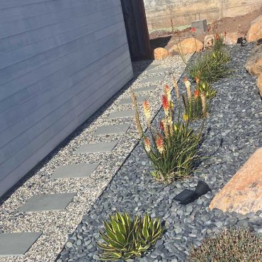 pathway around garage after succulent garden design with mexican pebbles and succulents