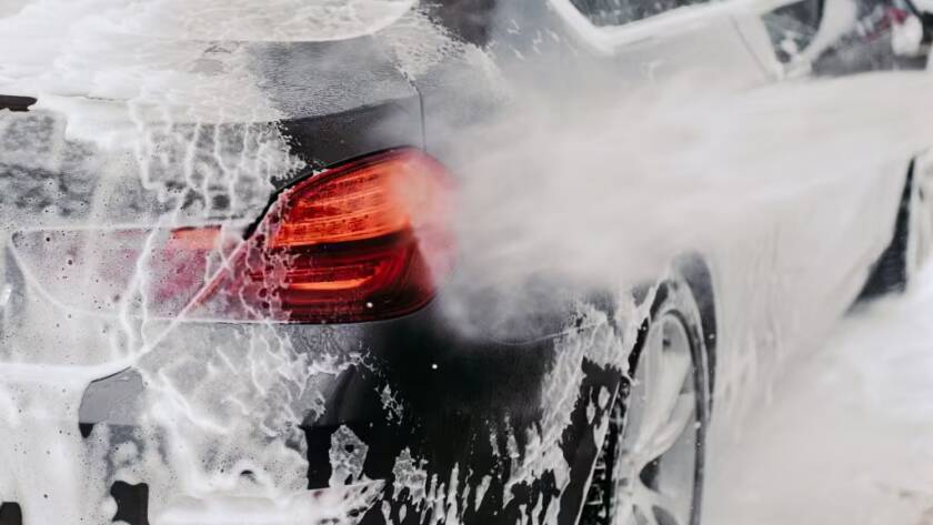 Rinsing snow foam off of a car by Wittmann Detailing in Springfield Missouri