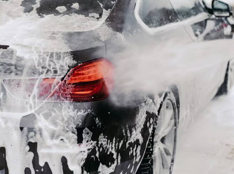 Rinsing snow foam off of a car by Wittmann Detailing in Springfield Missouri